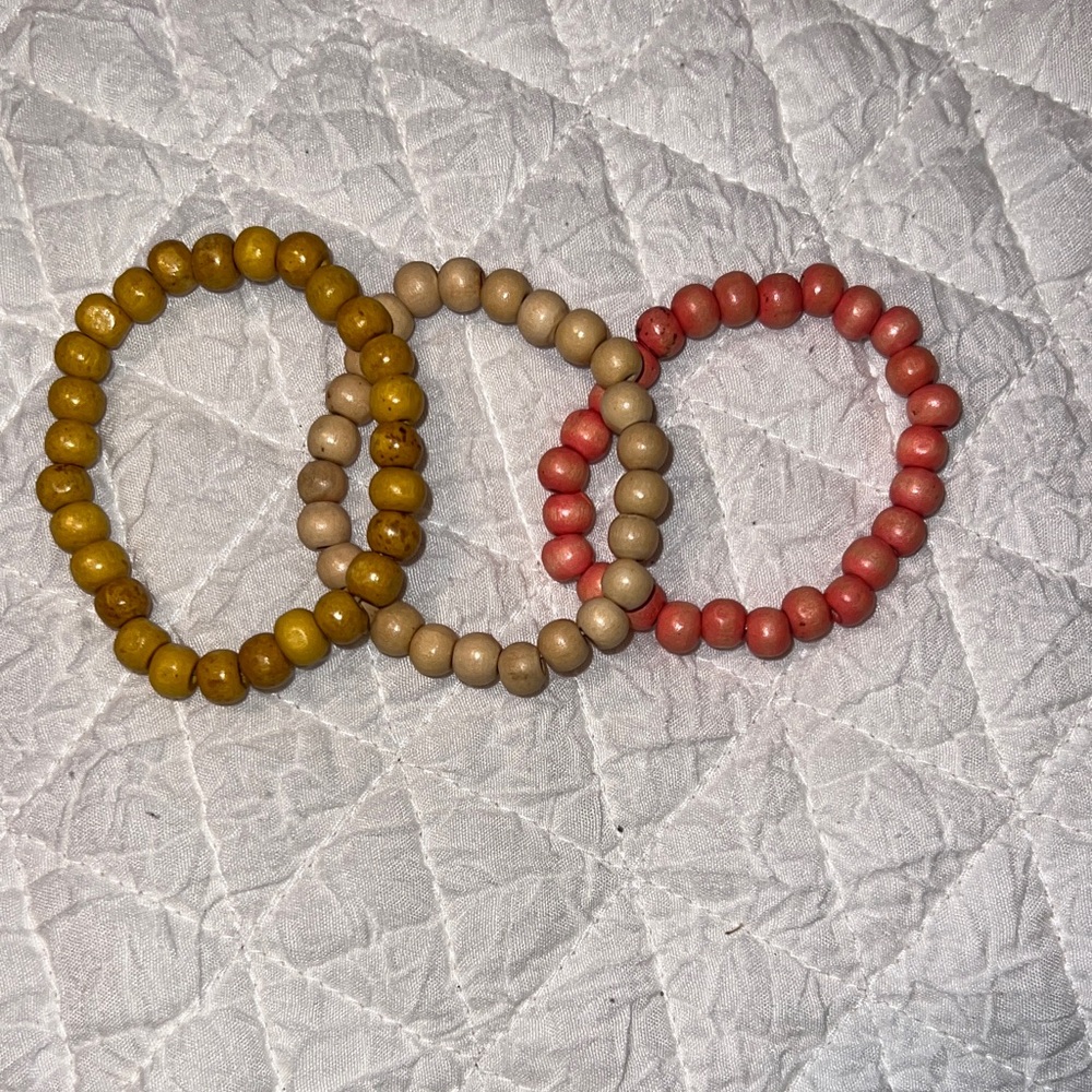 Set of Three Wood Beaded Bracelets in Yellow, Beige, and Pink